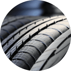 Close-up view of multiple car tires showcasing tread patterns and rubber texture, ideal for automotive and tire-related content.