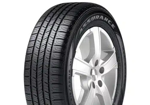Close-up of a black car tire labeled "Assurance" mounted on a silver alloy wheel, showcasing a tread design suitable for improved traction and performance. Ideal for drivers seeking reliability and safety on the road.