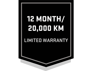 Black and white warranty badge indicating a 12 month or 20,000 km limited warranty for vehicle or product services.