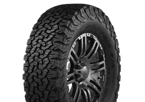 All-terrain tire with aggressive tread design mounted on a stylish black alloy wheel, ideal for off-road and rugged terrain driving.