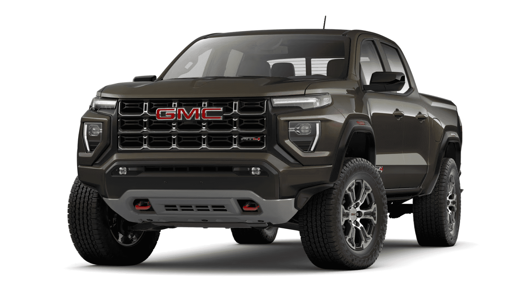 2023 GMC Canyon AT4 in dark green color, showcasing bold design with a prominent grille featuring the GMC logo, off-road tires, and rugged stance, ideal for adventure and outdoor activities.