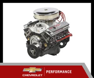Chevrolet performance engine featuring a polished aluminum intake manifold, chrome air cleaner, and red spark plug wires, designed for high horsepower and enhanced performance.