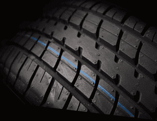 High-performance tire showcasing detailed tread design with a blue stripe, optimized for traction and stability on various road conditions. Ideal for enhancing vehicle performance and safety.