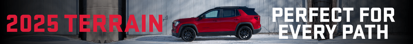 2025 GMC Terrain showcased in a striking red color against an industrial backdrop, highlighting its versatility for various terrains and adventures. Perfect for every path, this modern SUV features a stylish design and robust capabilities.